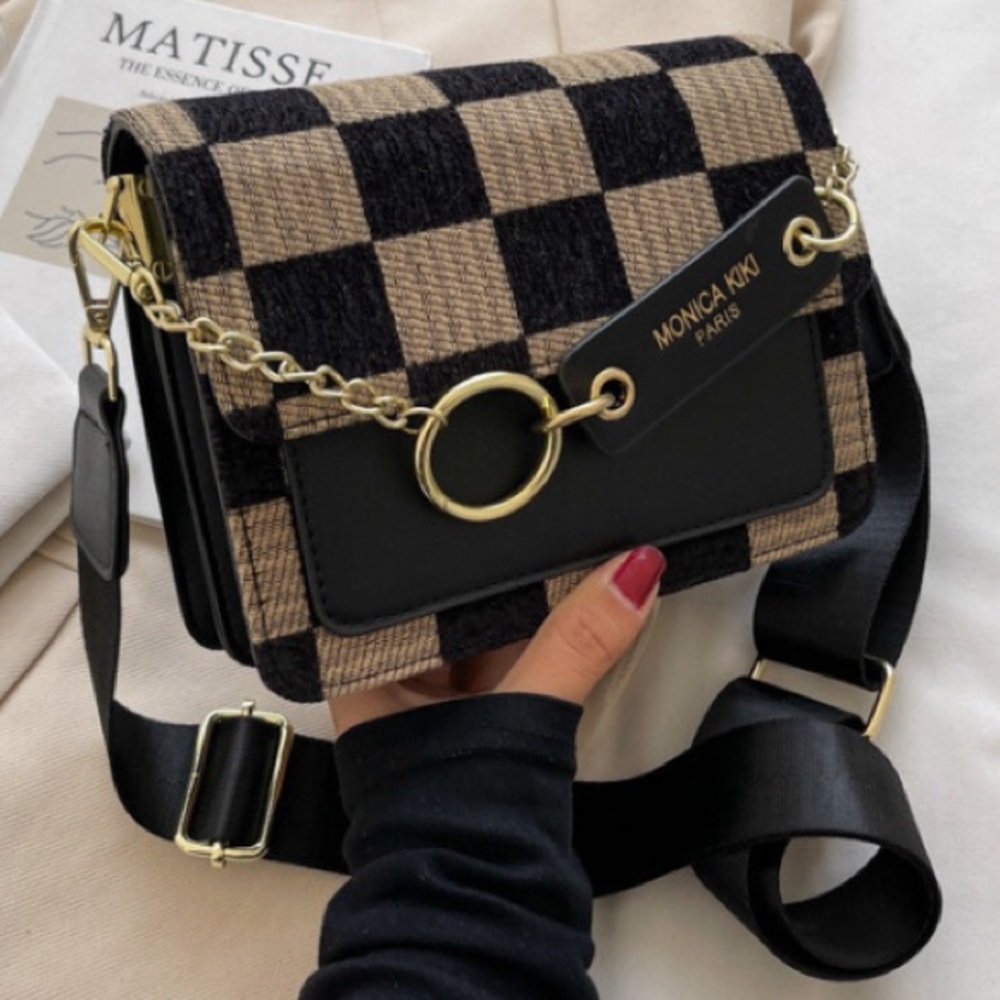 Black leather purse with beige and black checker front with inside pockets